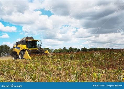 Combine Harvester on Field with a Blue Sky and Fluffy Clouds Stock Photo - Image of farmland ...