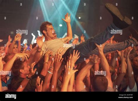 Wild music moves. a man crowd surfing at a music festival Stock Photo ...