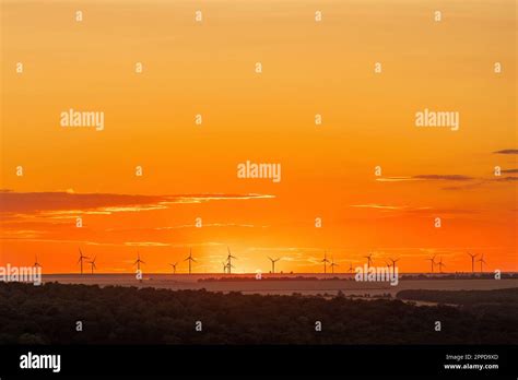 Wind turbines on field at sunset Stock Photo - Alamy