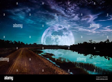 Photo Manipulation. Beautiful night sky with many stars. Landscape of blue sky with super moon ...