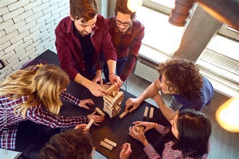 Top view friends play indoor board games. Stock Photo | Adobe Stock