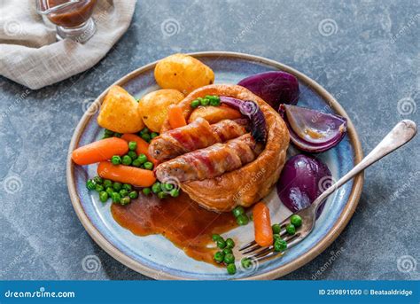 Toad-in-the-hole stock photo. Image of carrots, bangers - 259891050