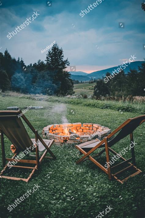 Campsite With Fire Pit And Two Empty Chairs. Burning Campfire with ...