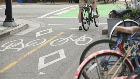 Urban Cycle Path Downtown Vancouver. Cyclists Using The Designated Bicycle Lane Which Is ...