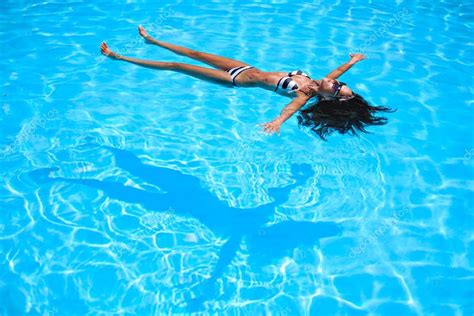 Girl floating in the pool — Stock Photo © sasamihajlovic #120985596