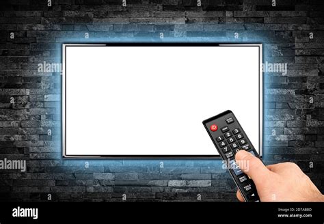 hand with remote on empty black flat tv screen display with copy space ...