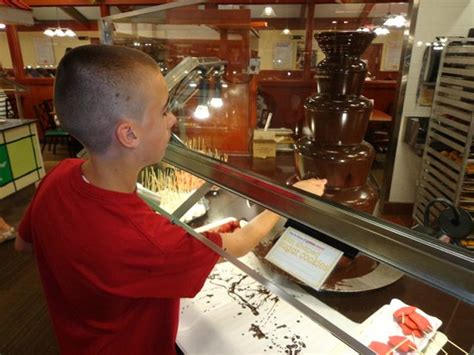 My son dipping fresh fruit into the Golden Corral chocolate fountain ...