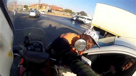 Watch This Motorcyclist Run Down a Carjacker