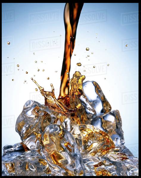 Soda pouring over ice - Stock Photo - Dissolve