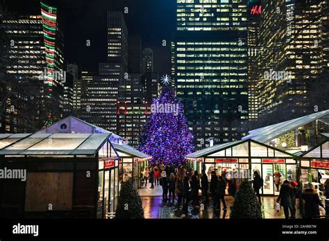 A Christmas Tree shines over the Winter Village and Holiday Shops at Bryant Park in New York ...