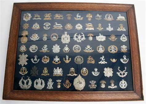 Framed Display of Sixty Nine British Regimental Cap Badges mostly of ...