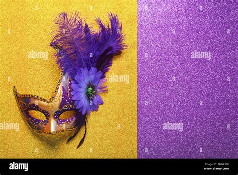 Venetian carnival mask with copy space over bright yellow and purple ...