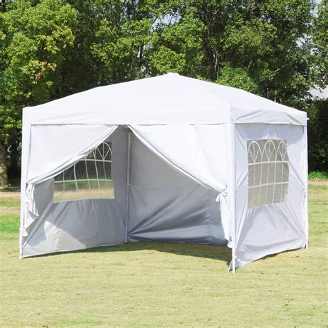 a white tent sitting on top of a lush green field