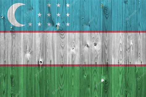 Premium Photo | Uzbekistan flag depicted in bright paint colors on old wooden wall.