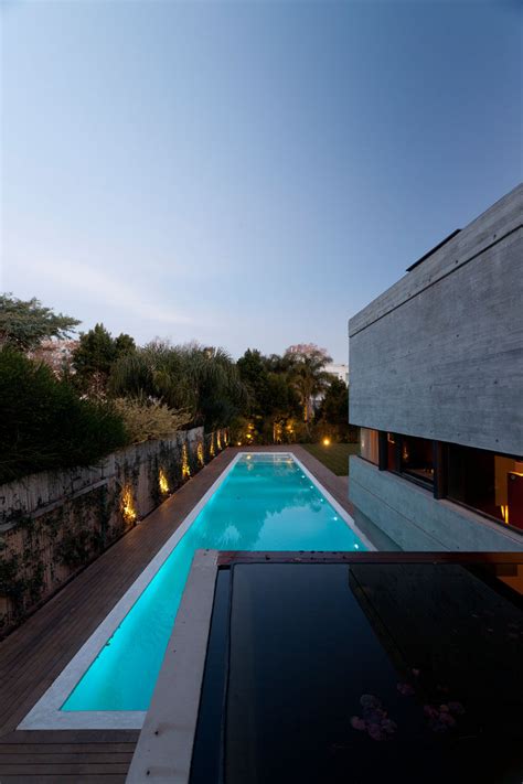 A Concrete House With A Pond And A Green Roof Incorporated Into Its ...