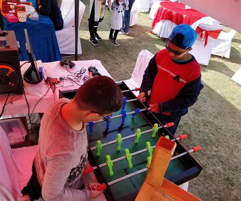 two people playing foo pong at an outdoor event