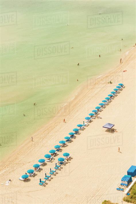 Aerial view of lawn chairs on beach - Stock Photo - Dissolve