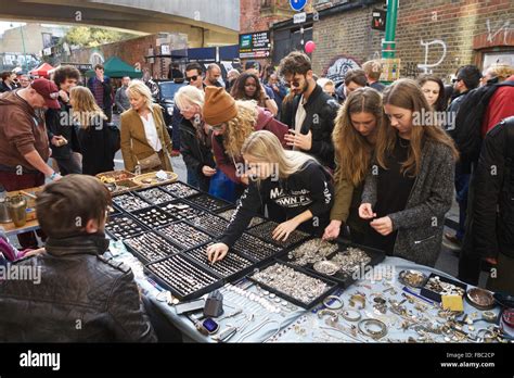 Brick Lane market London, UK: A market stall holder selling jewellery to tourists and locals. A ...