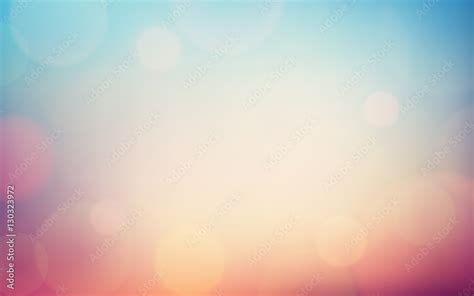 Abstract Bokeh and lens flare pattern on blue and pink color in vintage filter background ...