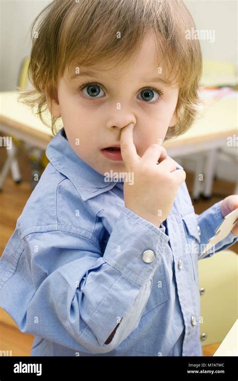 Portrait of a boy picking nose Stock Photo - Alamy