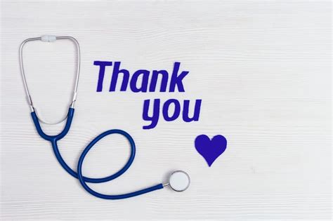 Premium Photo | Medical stethoscope, blue heart and text "thank you" on white wooden background ...