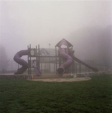 a foggy playground with slide and play equipment