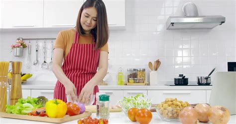 Young Asian woman cooking in kitchen at home. 11271651 Stock Photo at ...