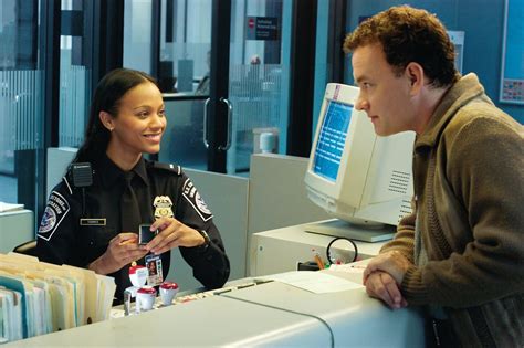 "The Terminal" movie still, 2004. L to R: Zoe Saldana, Tom Hanks. PLOT: An Eastern European ...