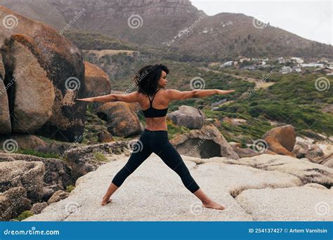 Barefoot Woman Practicing Yoga Exercises Outdoors while Standing on a Big Rock Stock Image ...