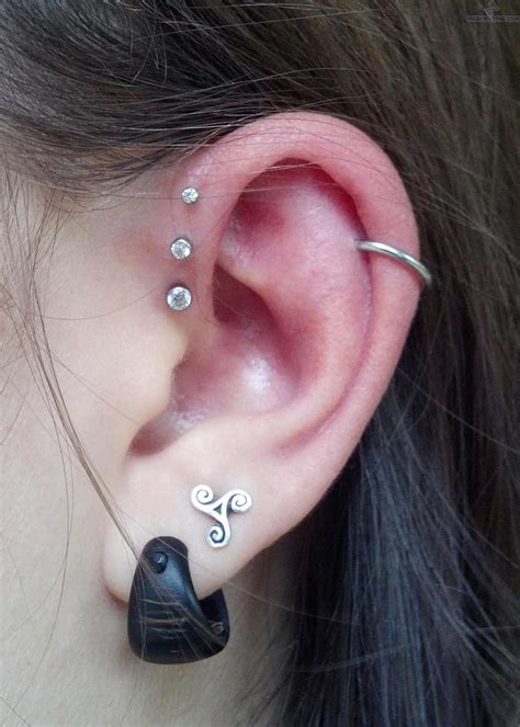 an ear with two different piercings attached to it