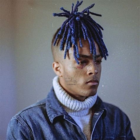 a man with blue dreadlocks on his head