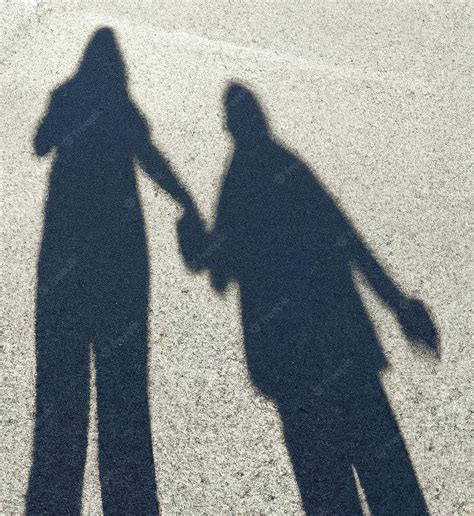 Premium Photo | Close up of shadow of people holding hands created ...