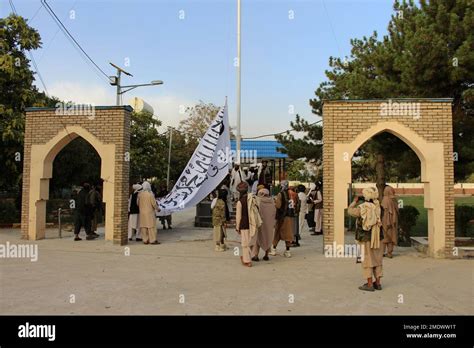 Taliban fighters raise their flag at the Ghazni provincial governor's house, in Ghazni ...