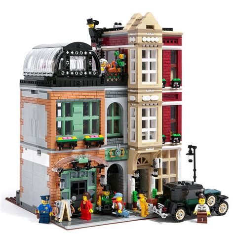 a lego model of a building with people standing in front of it and cars parked outside