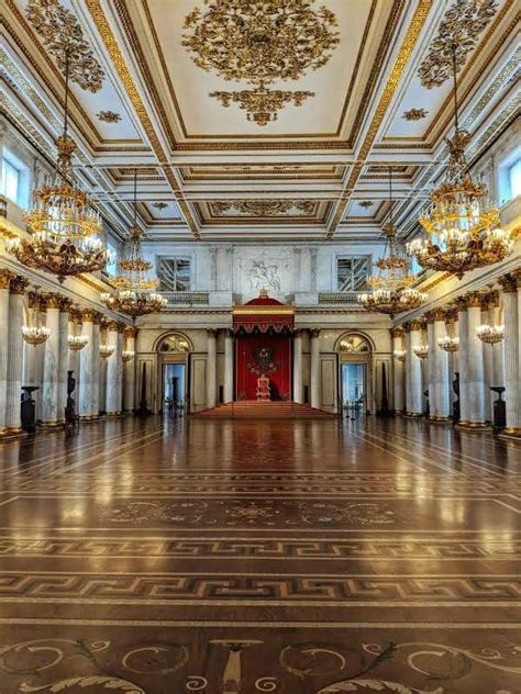 an ornately decorated ballroom with chandeliers and gold trimming on the ceiling