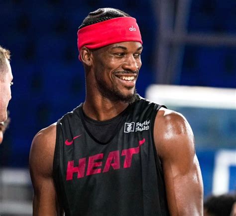 Jimmy Butler's hair in braids, face jewlery gone at Heat camp