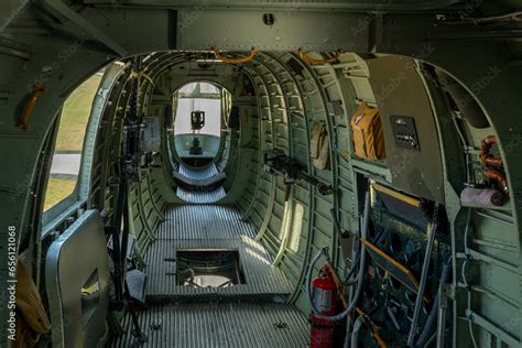 interior aft of B-24 bomber as it climbs away from an airport with view ...