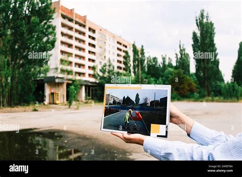 Pripyat, Ukraine - 23 June, 2019: Tour guide showing a picture of how ...