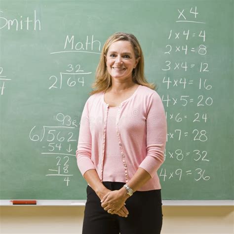 Teacher Standing with Notebook in Classroom Stock Photo - Image of pupil, person: 17049182