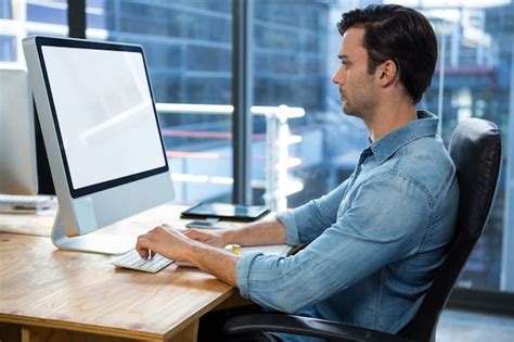 Premium Photo | Man working on desktop pc