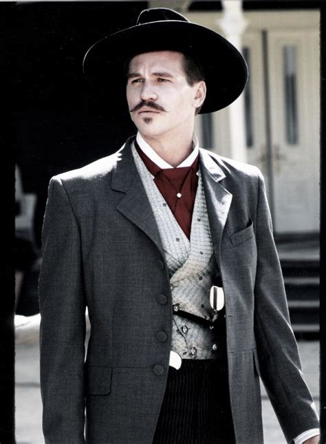 a man in a suit and hat standing on the street