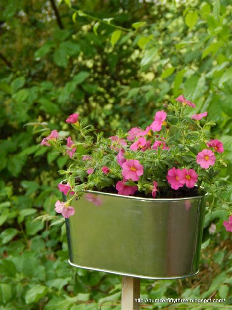 Add accent flowers with a galvanized planter - Jennifer Rizzo