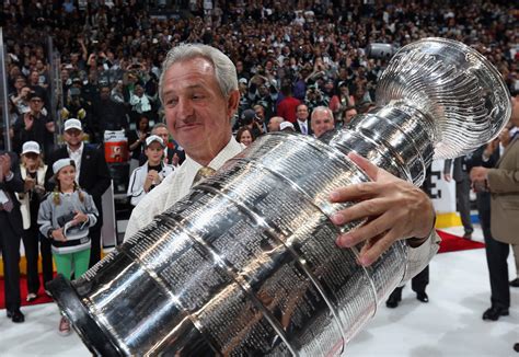 Darryl Sutter and Darryl Sutter's face hoist the Stanley Cup - SBNation.com