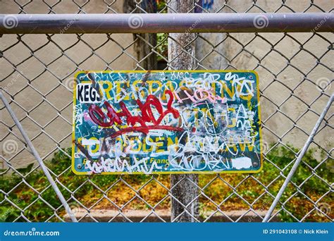 Graffiti on Sign with Messages on Chain Link Fence for Trespassing Loitering Forbidden by Law ...