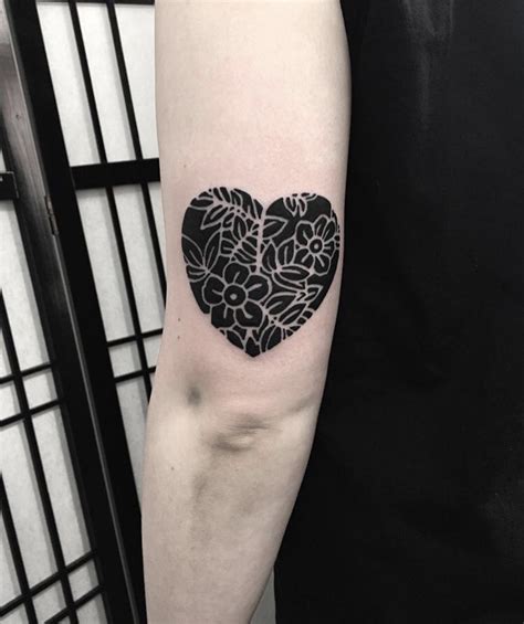 Negative space heart and flowers tattoo - Tattoogrid.net