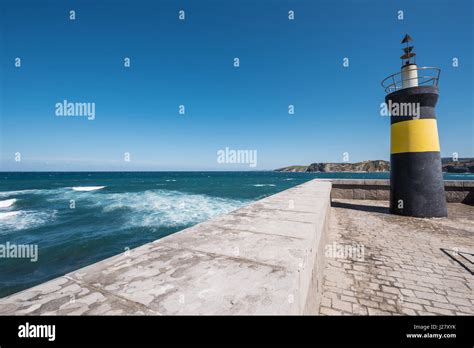 Lighthouse in Comillas port, Cantabria, Spain Stock Photo - Alamy