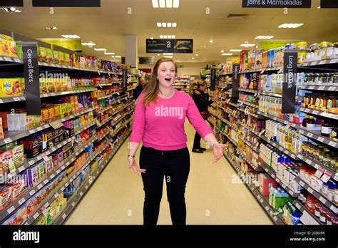 Female, part of a flash mob, singing opera in Waitrose supermarket, Alton, Hampshire, UK. 25.03. ...