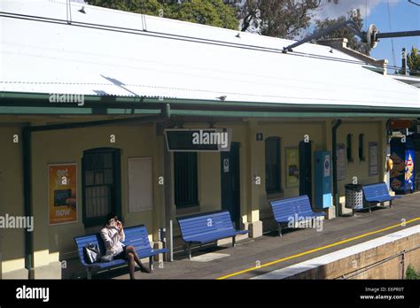 lady waiting for a train at Panania railway station on the East Hills railway line, sydney ...