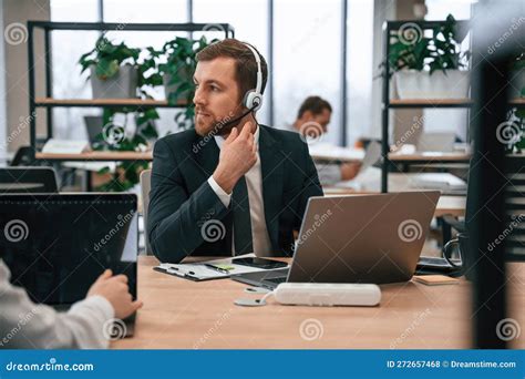 Man in Suit is Working in the Office by Laptop. with Woman that Siting by the Table Stock Photo ...