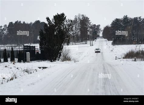 Legionowo, Poland - January 16, 2021: Winter weather conditions on the road. Snowfall and ...